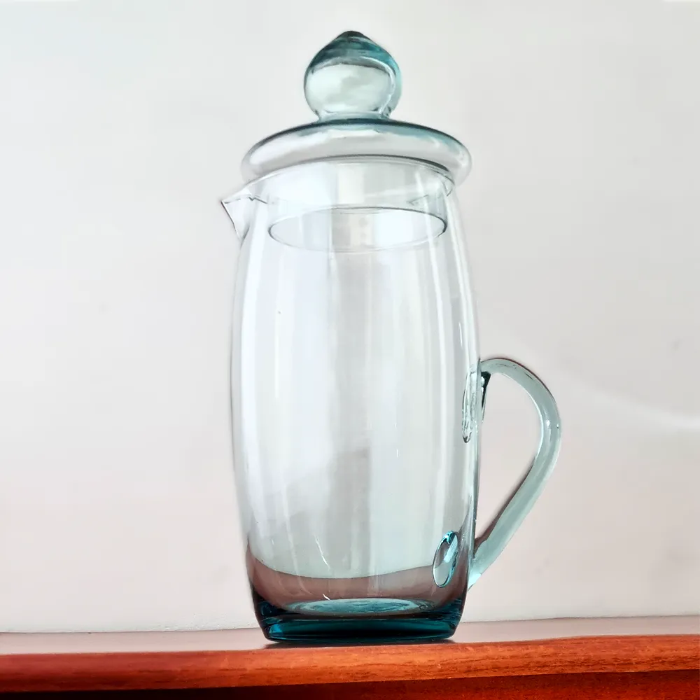 Jarra de vidrio transparente modelo Tabaco con su tapa, exhibida sobre una superficie de madera oscura.